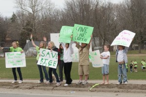 Kids holding signs to save Rice