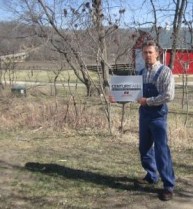 Weslie Phipps displaying Century Farm certificate