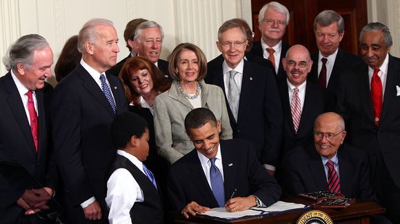 Obama signs the ACA